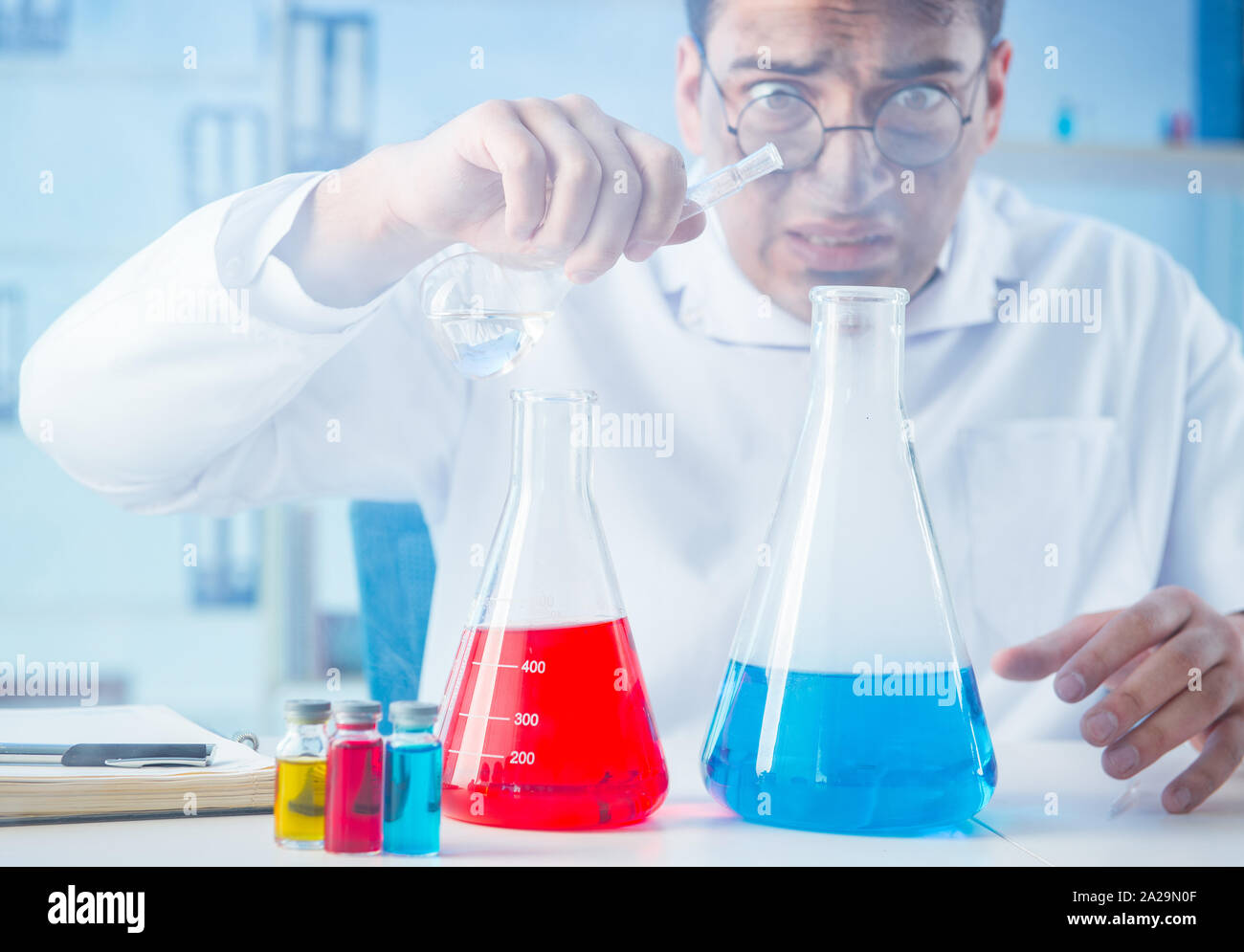 The funny mad chemist working in a laboratory Stock Photo
