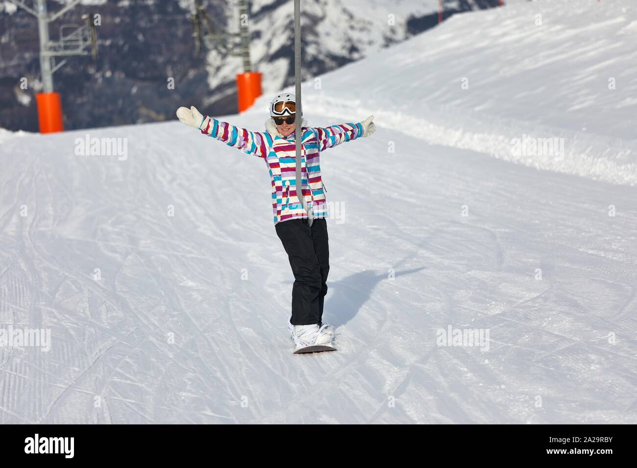 Female snowboarder using ski lift Stock Photo Alamy
