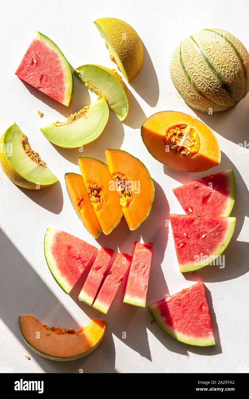 Slices of watermelon,cantaloupe and honeydew melon on the table,top view  Stock Photo - Alamy