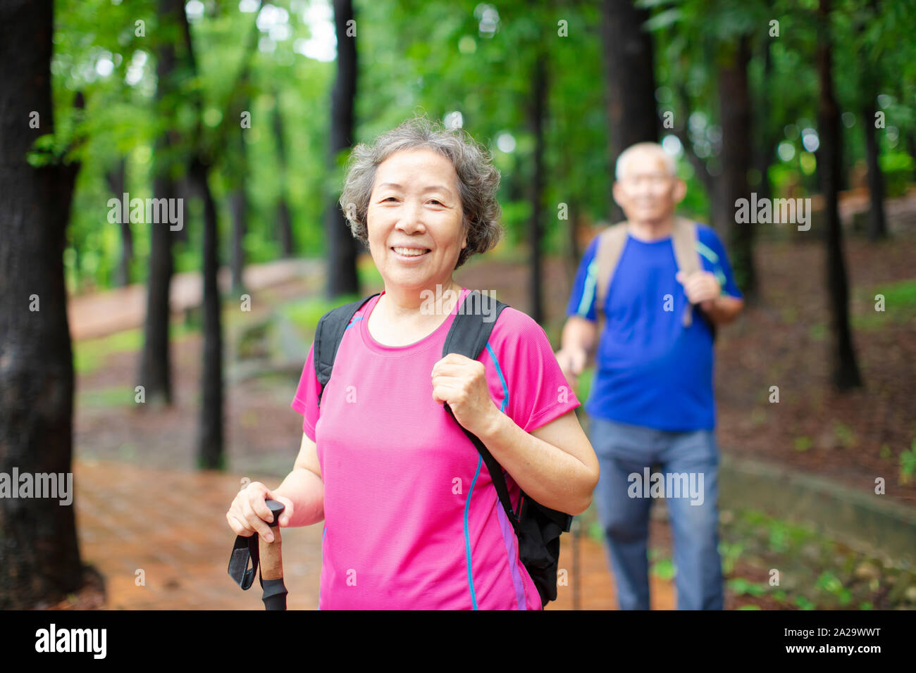 asian senior couple hiking on the forest park Stock Photo - Alamy