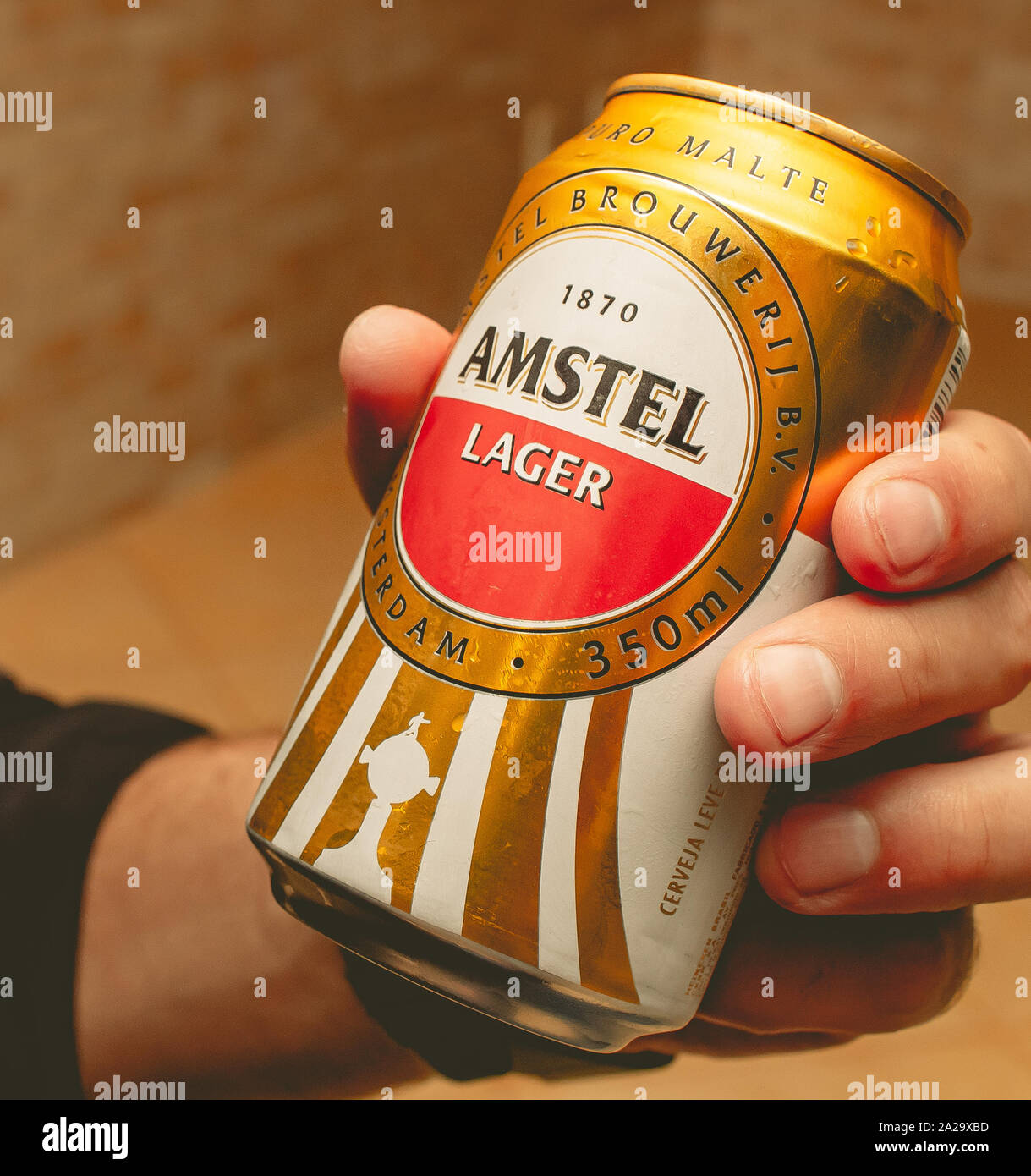 Man holding a canned beer by AMSTEL. Stock Photo
