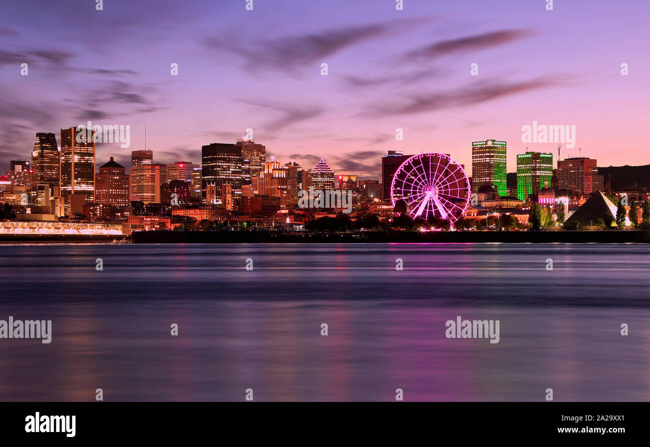 Montreal skyline illuminated at dusk reflected in Saint Lawrence River, Quebec, Canada Stock Photo