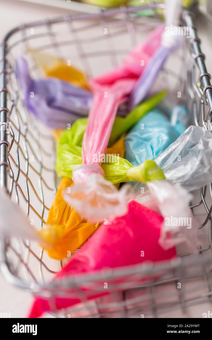 Piping bags with royal icing to decorate Easter sugar cookies Stock