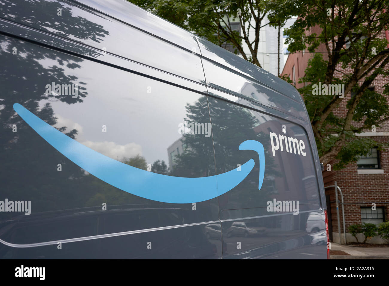 Portland, Oregon, USA - Sep 13, 2019: Closeup of the logo on an Amazon Prime branded van parked on the roadside in downtown Portland. Stock Photo