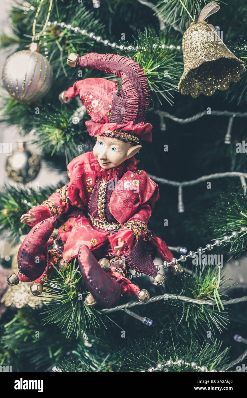 Christmas or New Year decorative toy. Joker Doll on Christmas tree. Close-up Stock Photo