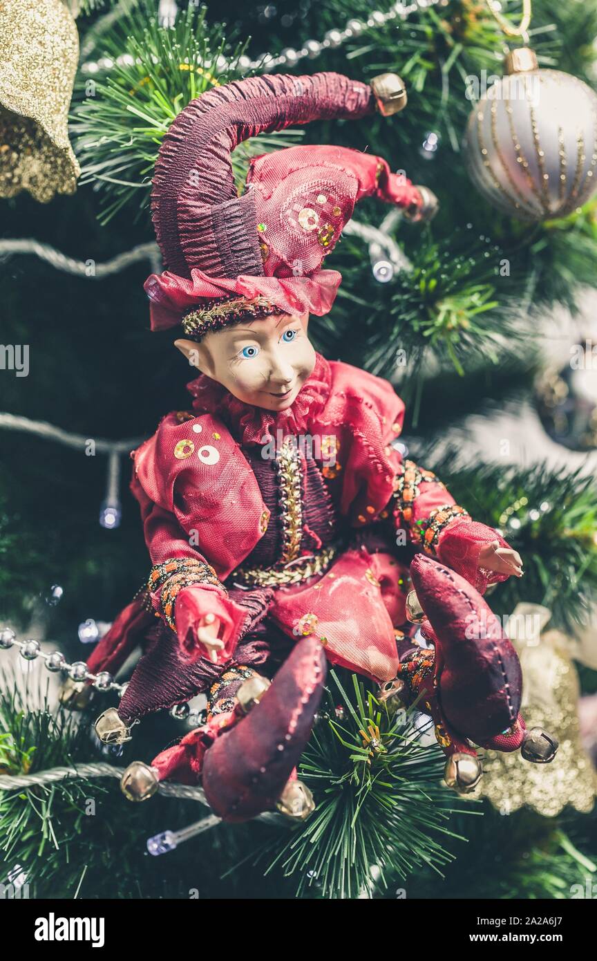 Christmas or New Year decorative toy. Joker Doll on Christmas tree. Close-up Stock Photo