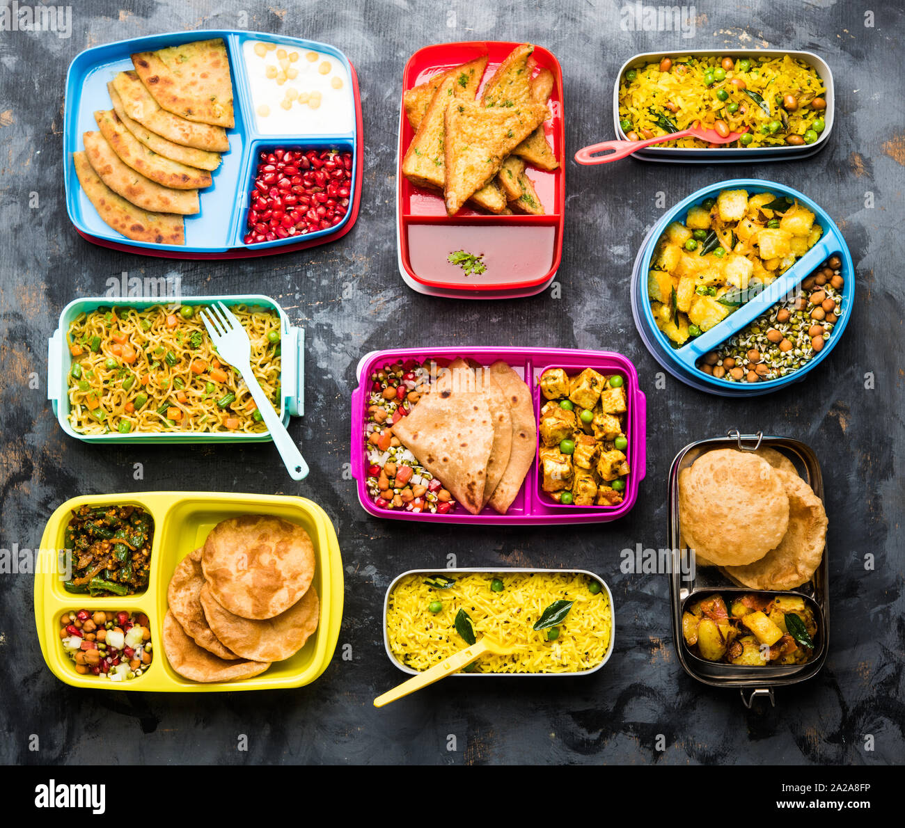group of Lunch Box / Tiffin for Indian kids, showing variety or multiple option or combination of healthy food for your school going children Stock Photo