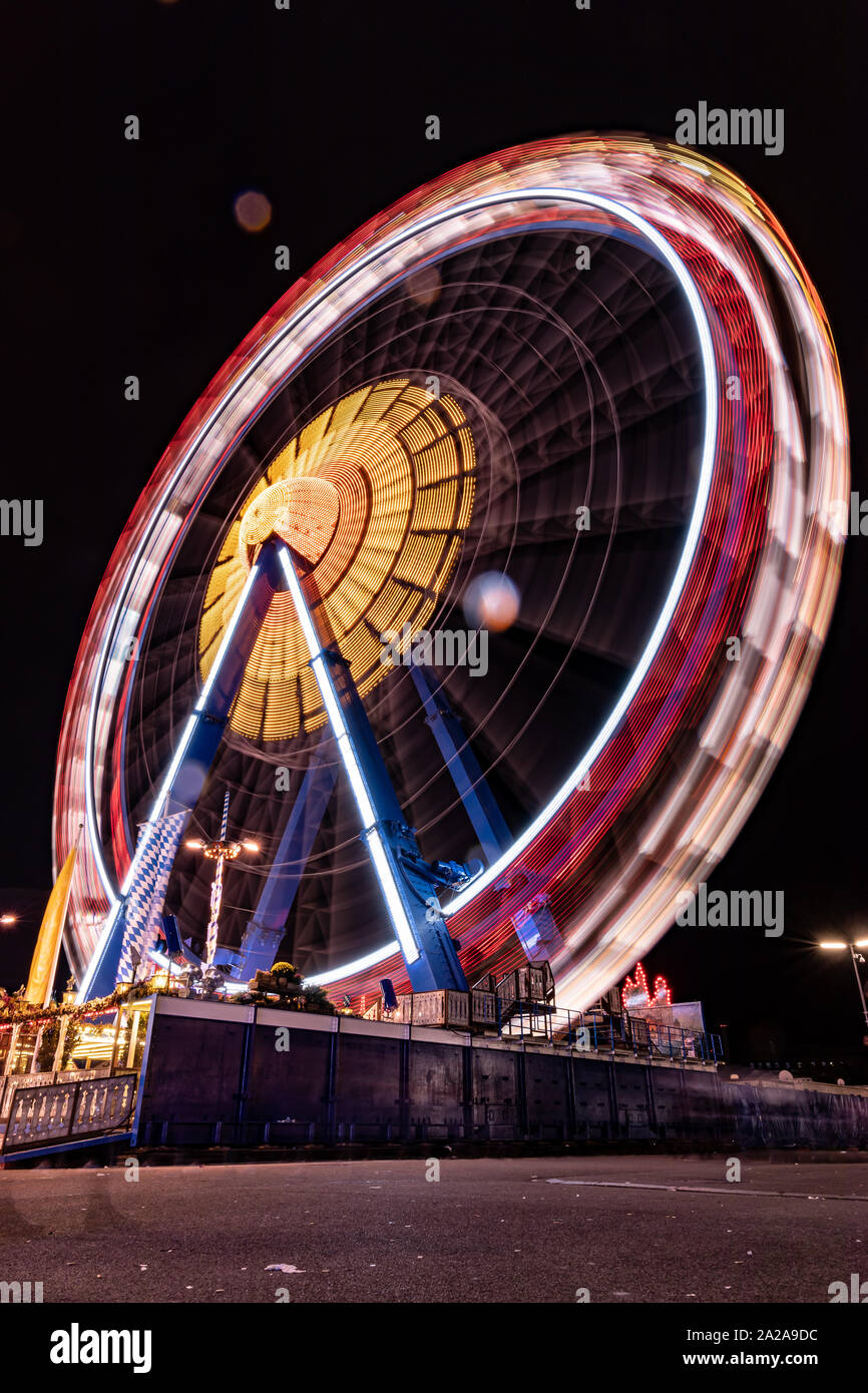 Munich, Germany - 2019, September 19: long exposure of the biggest ferris wheel at the Oktoberfest in Munich at night Stock Photo