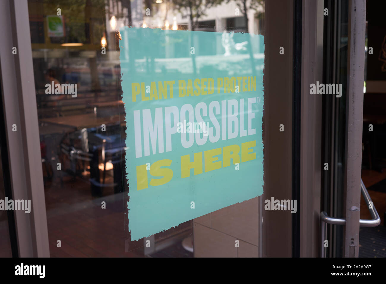 Portland, OR - Sep 6, 2019: A QDOBA Mexican Eats restaurant in downtown Portland advertises the availability of Impossible brand plant-based protein. Stock Photo