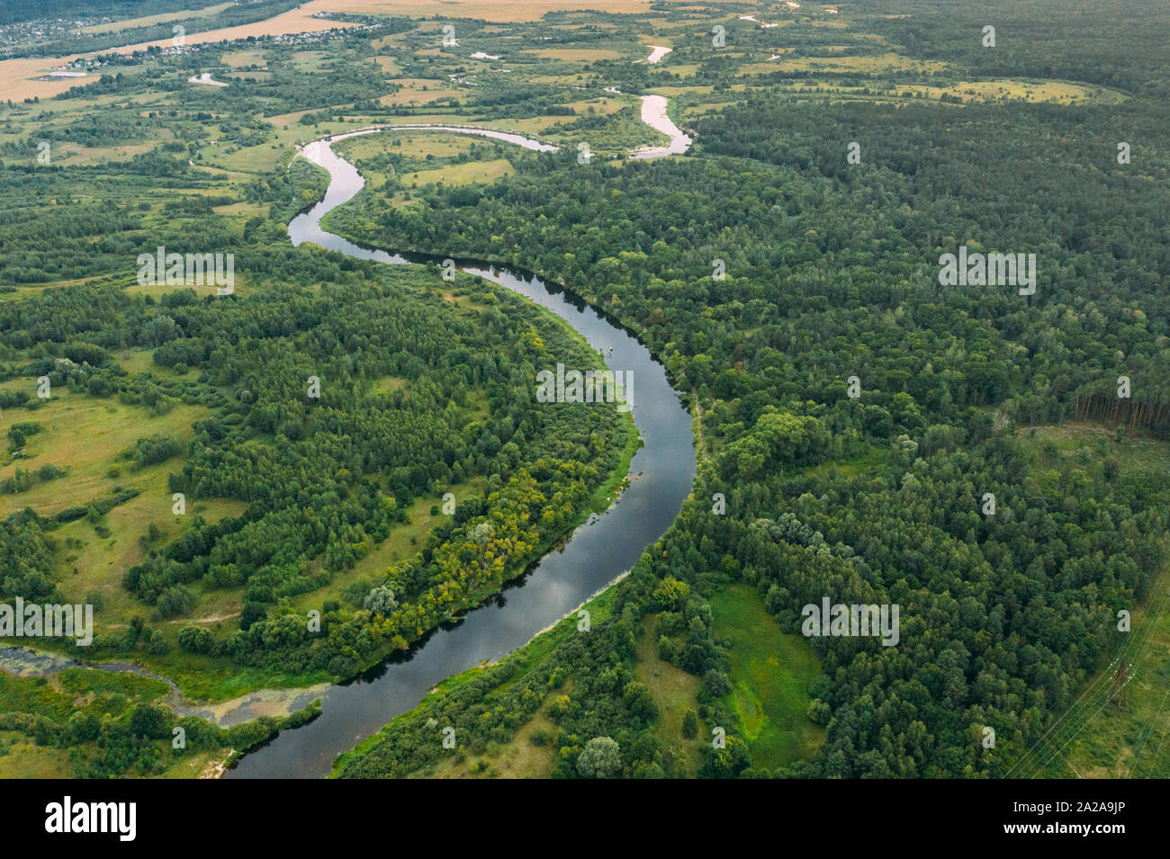 Aerial View Green Meadow, Forest And River Landscape In Spring Evening. Top View Of Beautiful European Nature From High Attitude In Summer Season. Dro Stock Photo