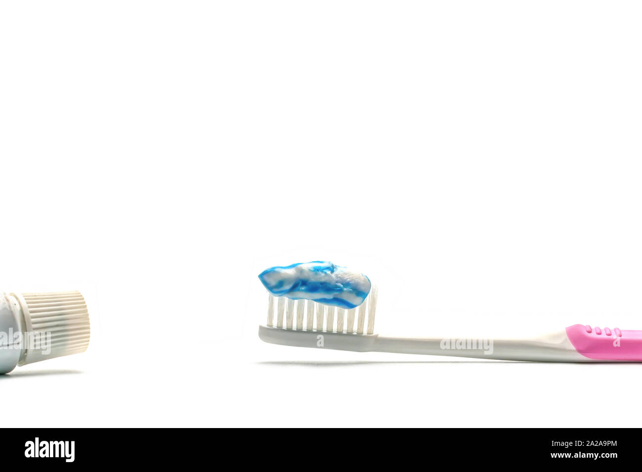 The toothpaste on the toothbrush on a white background Stock Photo - Alamy