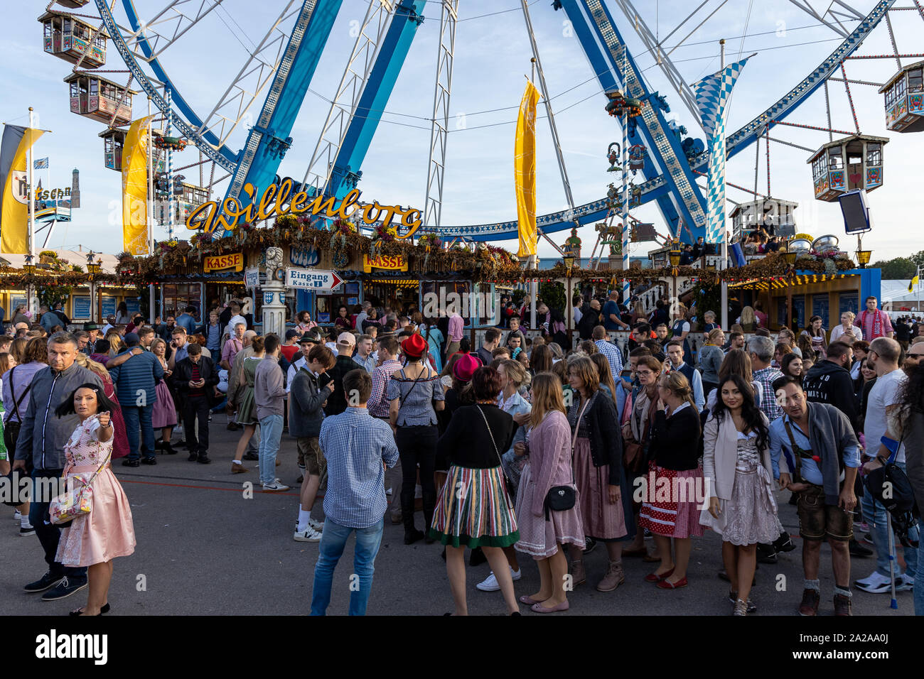Munich, Germany - 2019, September 19: people from all over the world walking in front of the rotating ferris wheel at the Oktoberfest in Munich Stock Photo