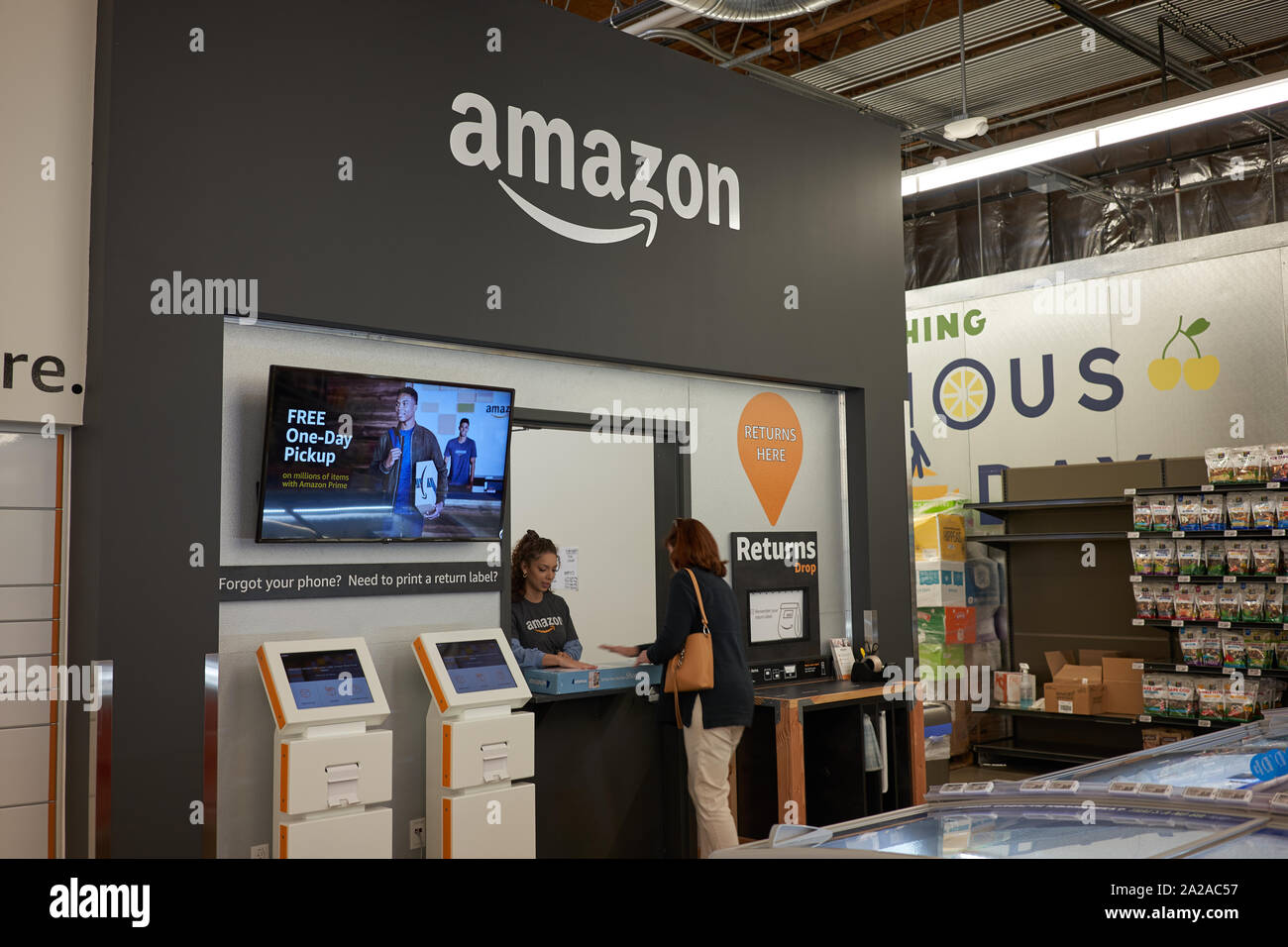 A customer returns a package at an Amazon Locker location in a Whole Foods Market grocery store in Lake Oswego, Oregon, on Friday, Sep 13, 2019. Stock Photo