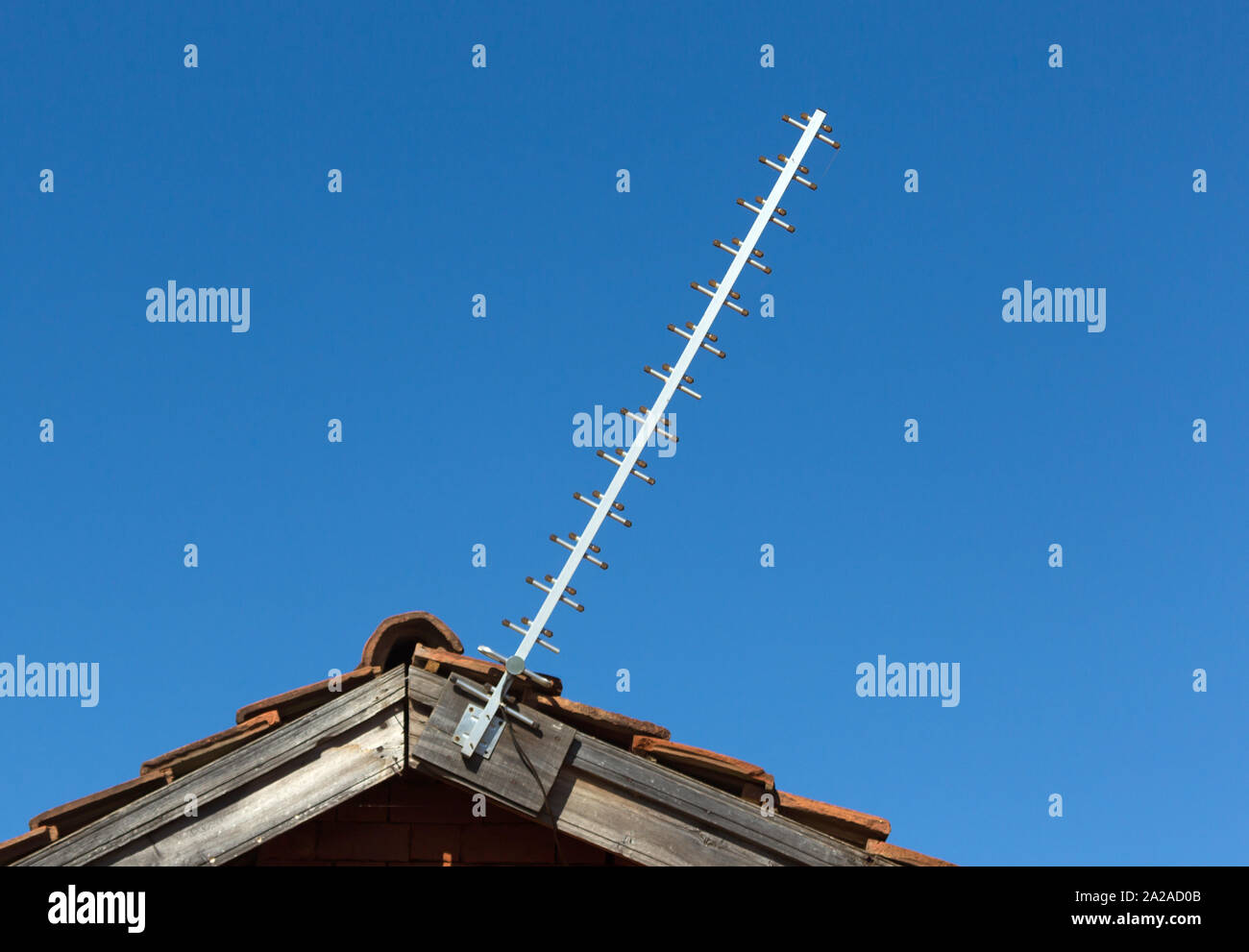 Simple old antenna on a roof, blue background Stock Photo - Alamy
