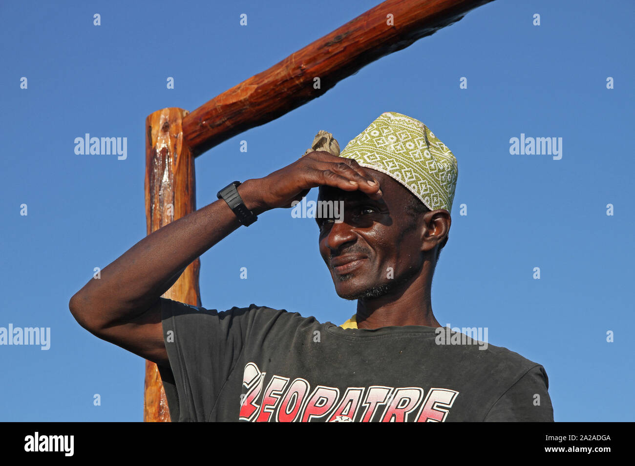 Boat rider looking into the distance, standing on a boat, Zanzibar, Unguja Island, Tanzania. Stock Photo