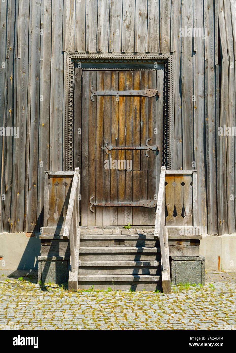 Wooden porch with and door. Openwork platbands Stock Photo