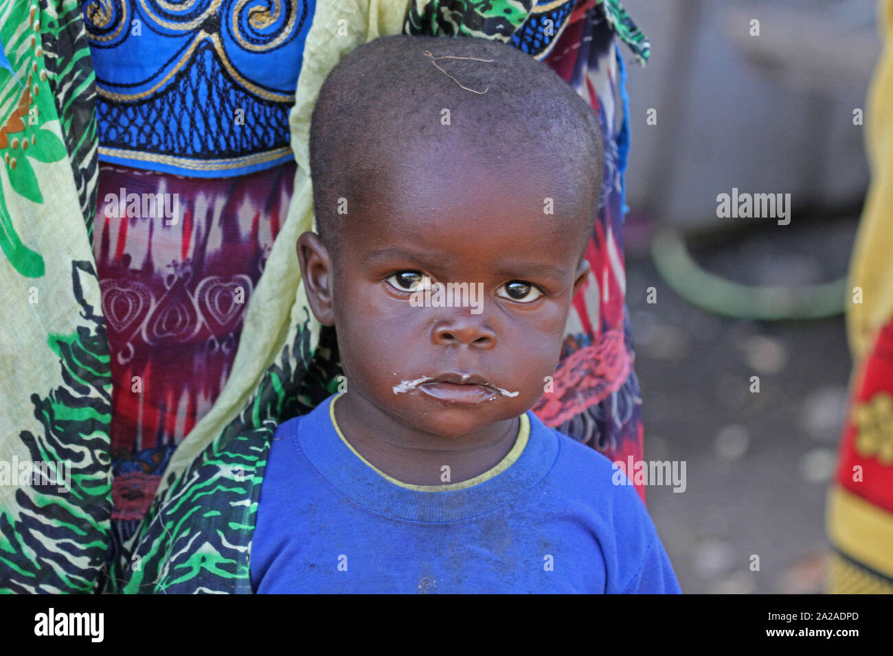 Little african toddler boy under mother, Zanzibar, Unguja Island, Tanzania. Stock Photo