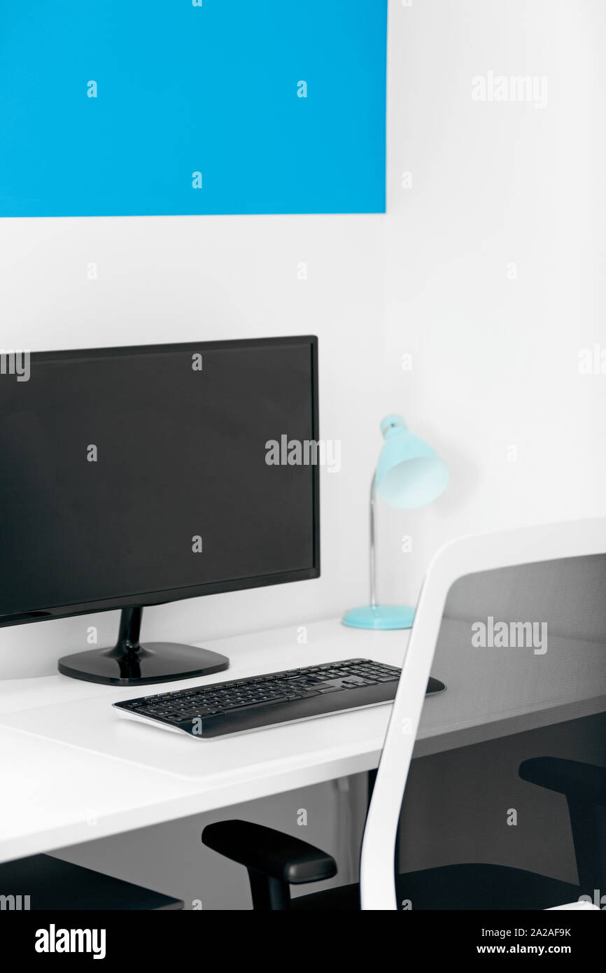Modern blue office desk with computer and lamp Stock Photo Alamy