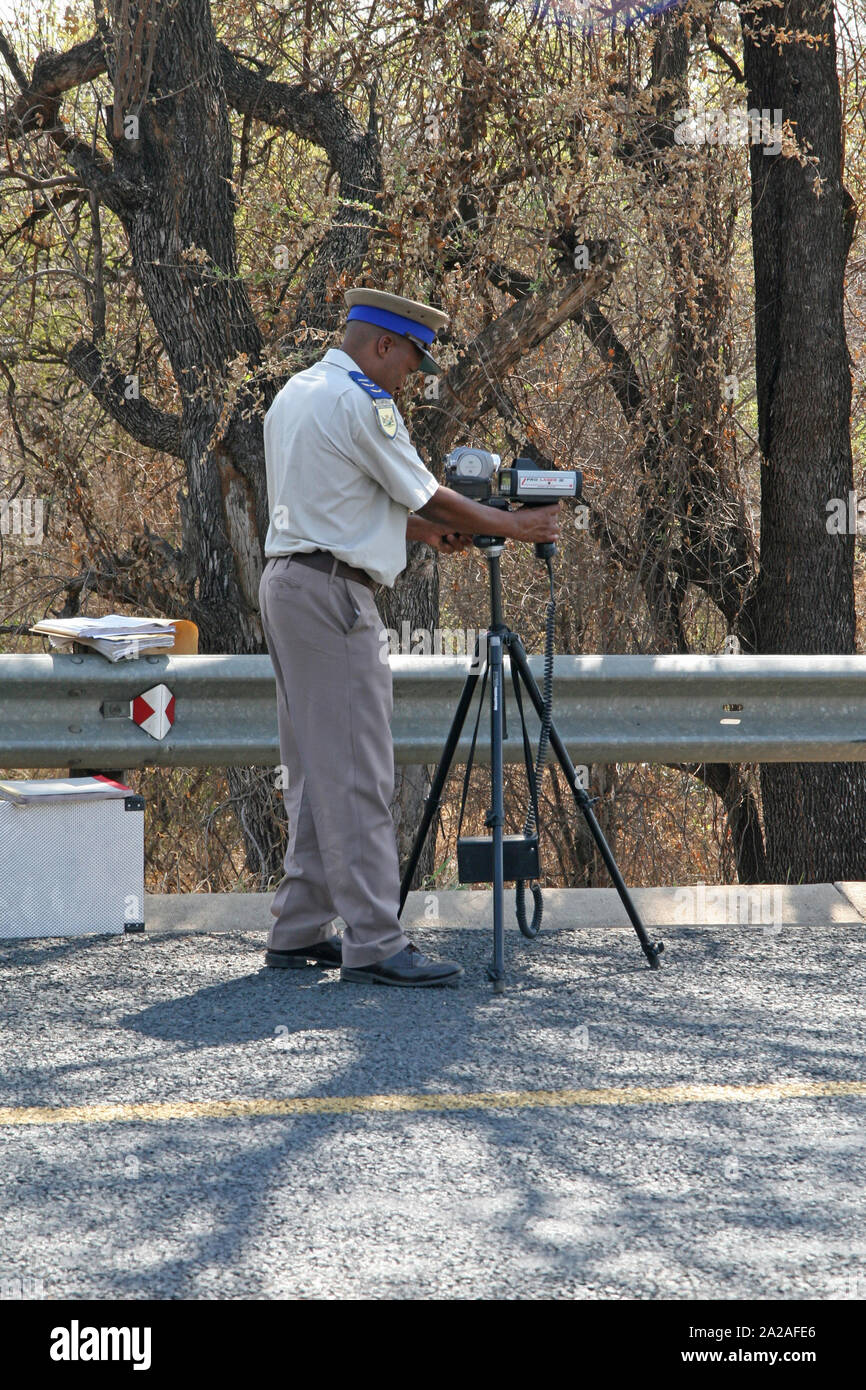 Traffic policeman with speed camera on Highway, outskirts of Nelspruit, Mpumalanga, South Africa. Stock Photo