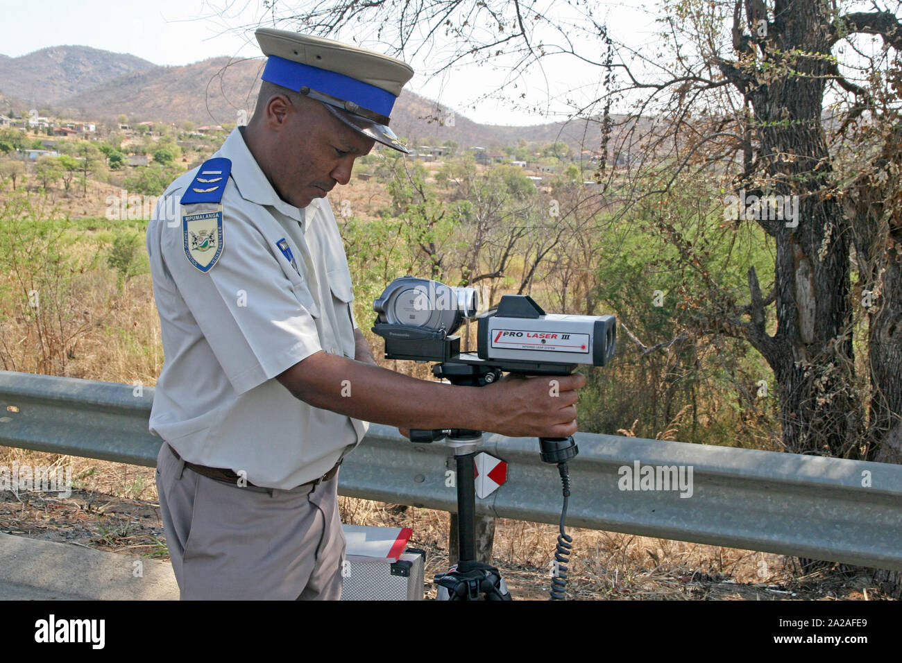 Traffic policeman with speed camera on Highway, outskirts of Nelspruit, Mpumalanga, South Africa. Stock Photo