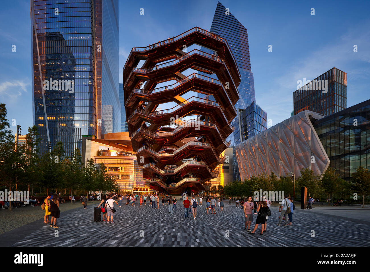Hudson Yards esplanade with The Vessel (staircase) and the Shed at sunset in summer. Midtown West, Manhattan Stock Photo