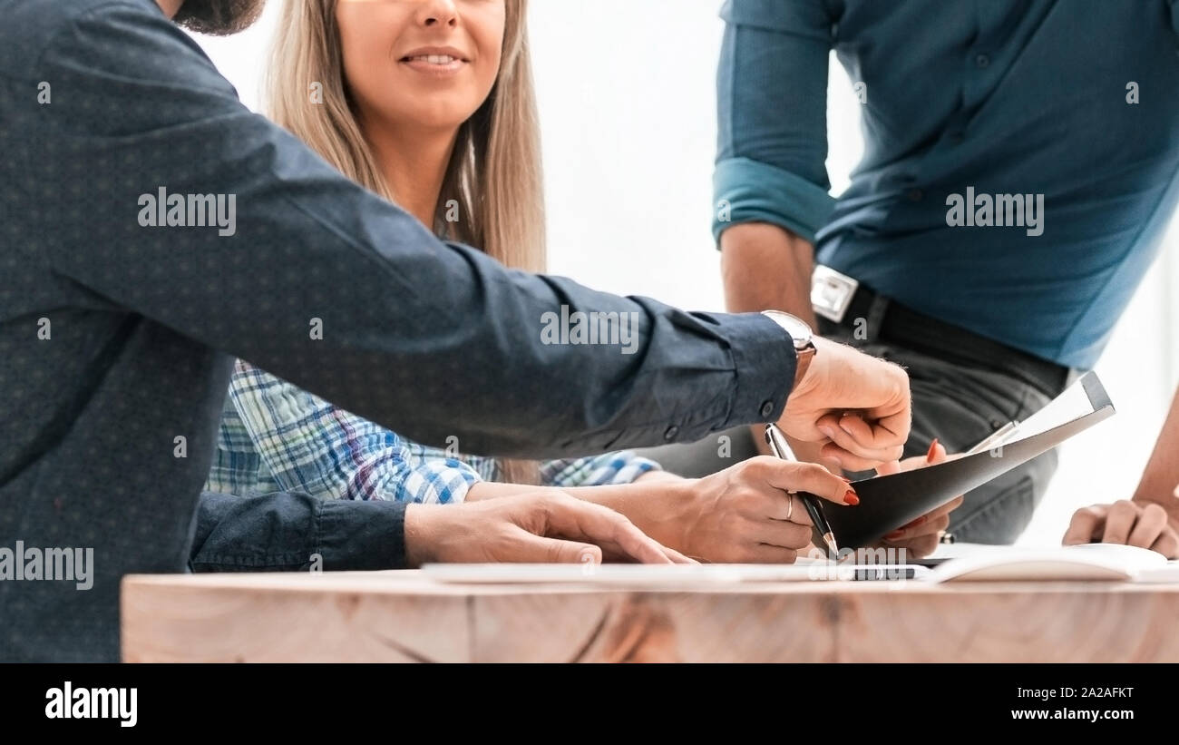colleagues extending their hands to each other for a handshake Stock Photo