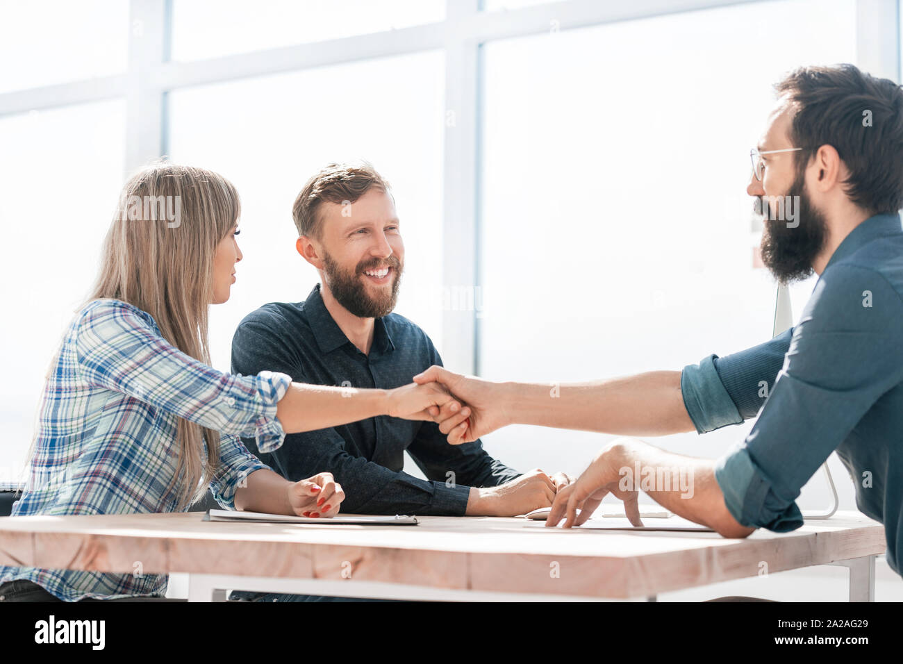 smiling business partners handshake during a business meeting Stock ...