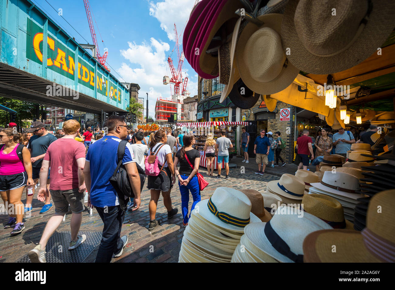 LONDON - JUNE 18, 2017: Visitors browse the food and retail shops in the outdoor market in the bohemian neighborhood of Camden Town. Stock Photo