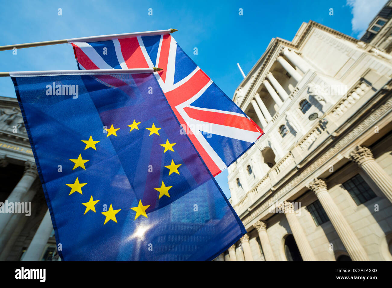 European Union and British Union Jack flag flying in front of the Bank of England as symbols of financial repercussions of the Brexit EU referendum Stock Photo