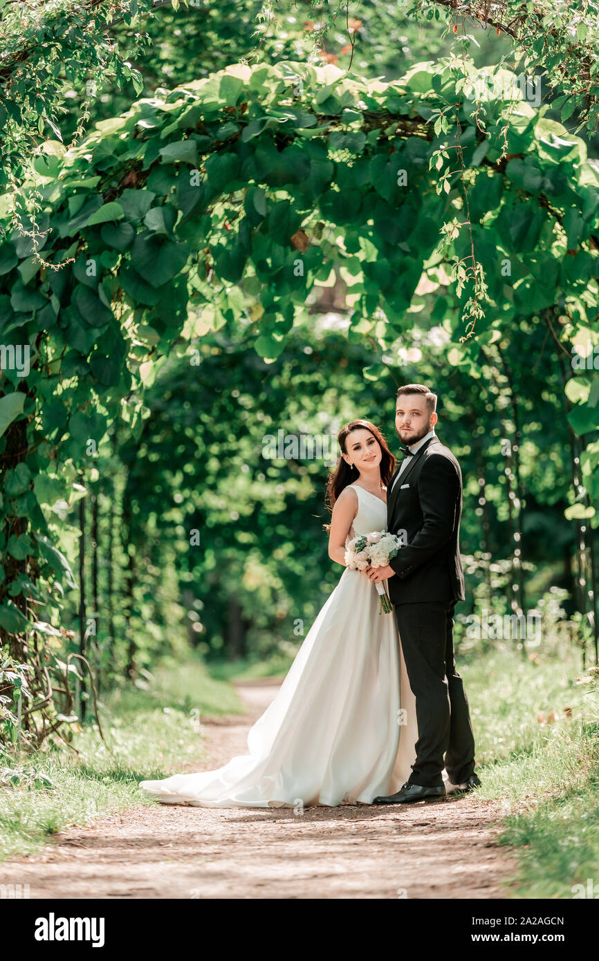 happy bride and groom standing under the wedding arch Stock Photo - Alamy