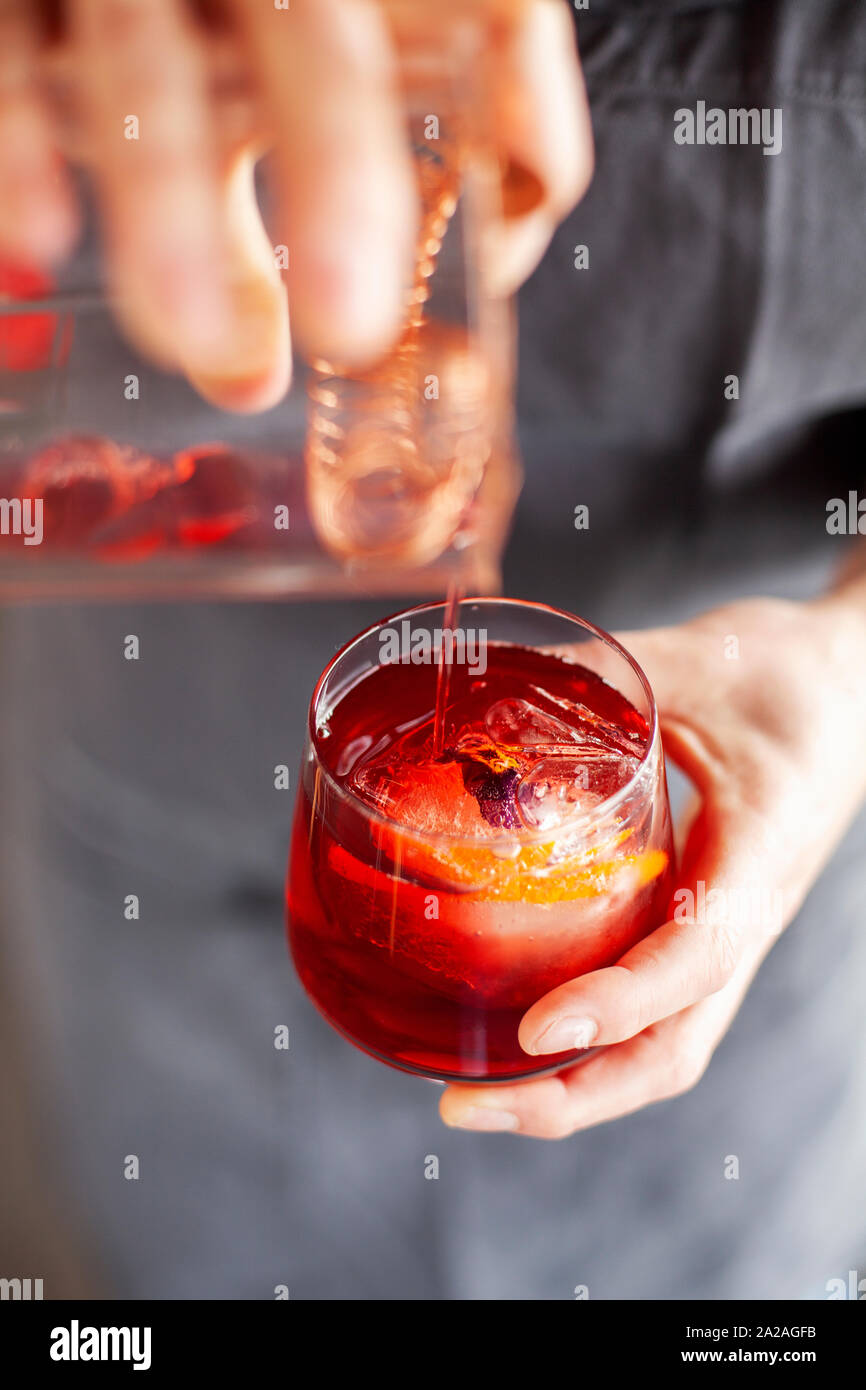 https://c8.alamy.com/comp/2A2AGFB/a-woman-with-a-tattooed-left-arm-pours-negroni-cocktail-in-to-a-small-tumbler-2A2AGFB.jpg