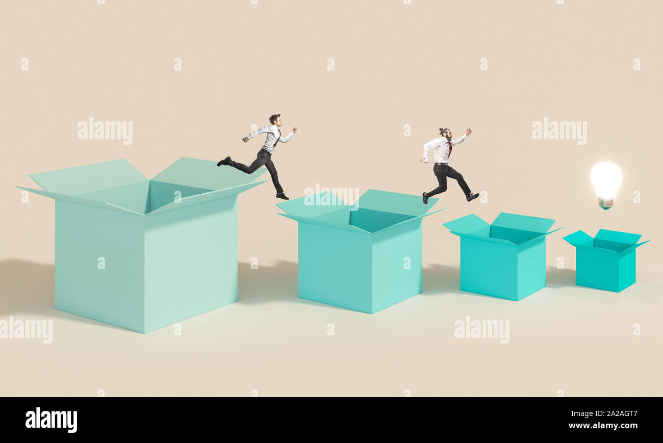 business people jump from one box to another to reach the light bulb that represents the winning idea. concept of competition in work and creativity. Stock Photo
