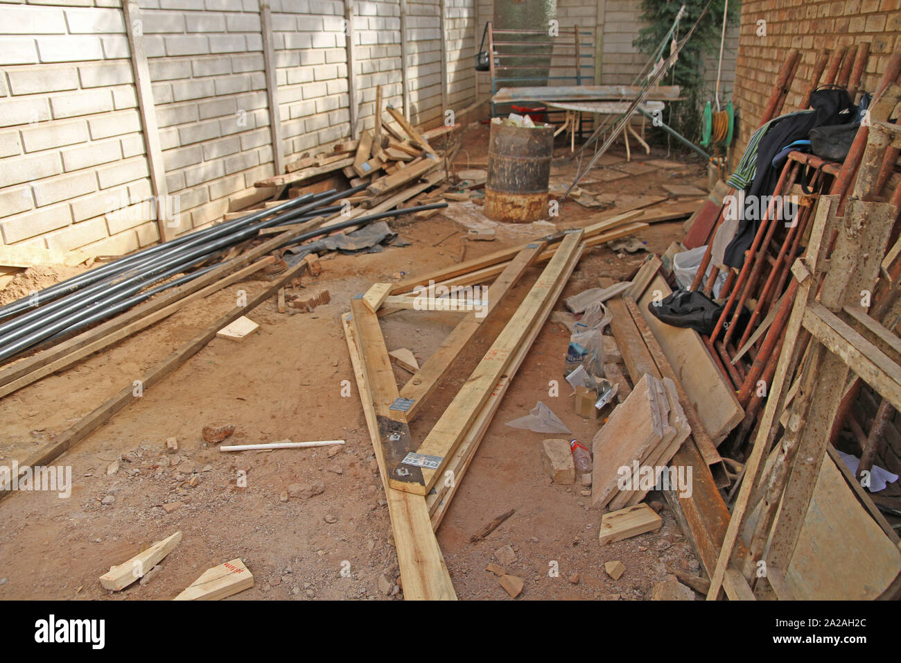 Wooden roof frame, pipes and steel frames at construction site