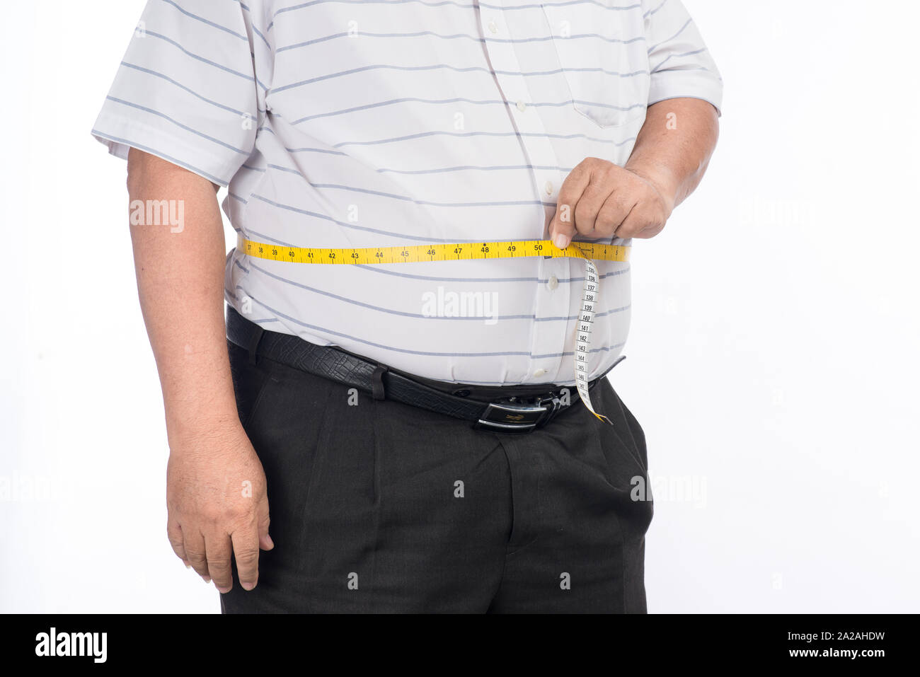 Fat mature man measuring his belly with measurement tape, isolated on white background Stock Photo