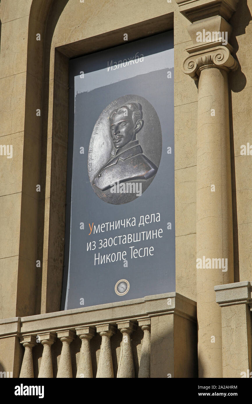 Poster in Serbian Cyrillic advertising Works of Art in the legacy of Nikola Tesla Exhibition on the front facade of the Nikola Tesla Museum, Central Belgrade, Serbia. Stock Photo