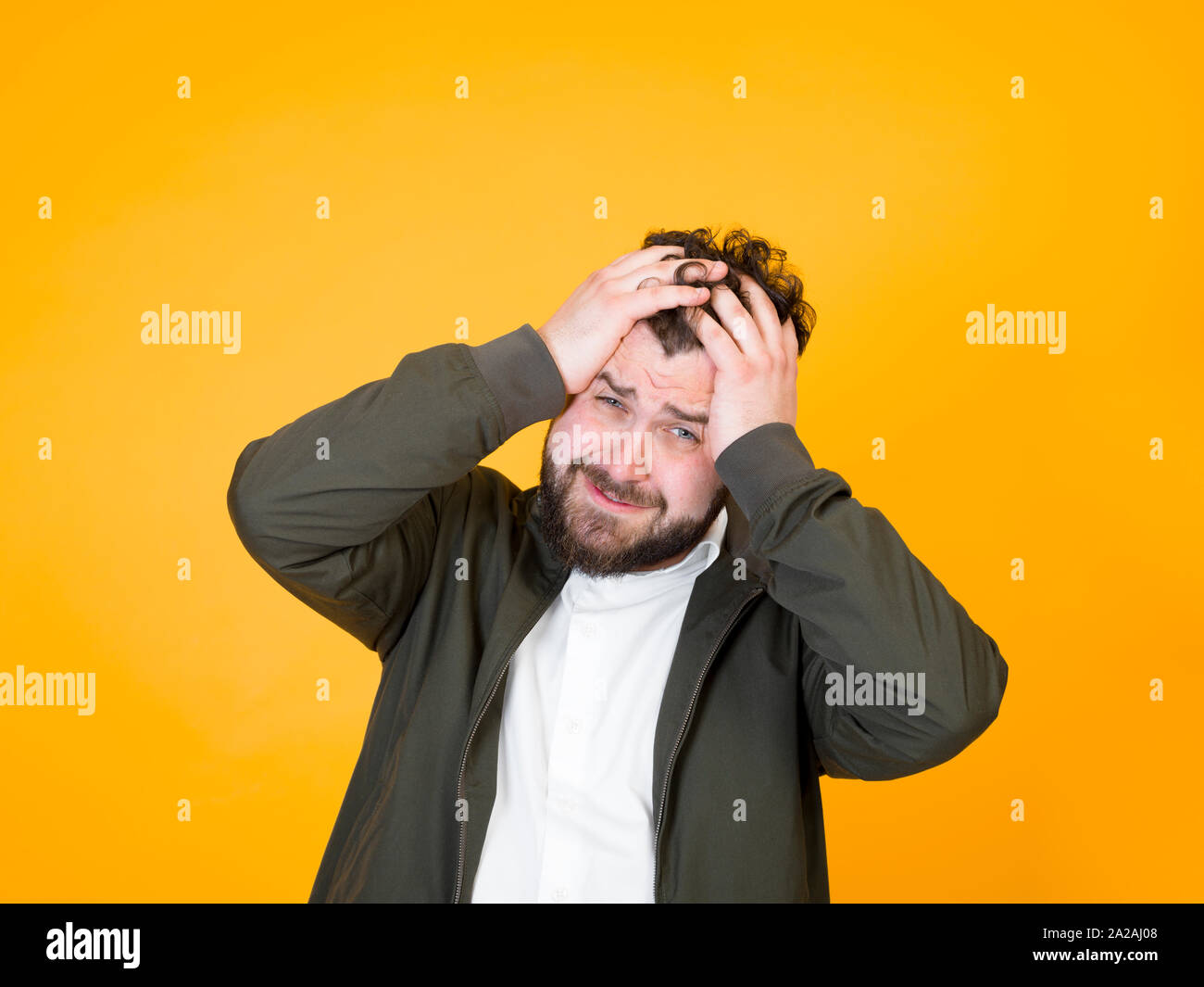 Cool Man With Black Beard And Black Hair Is Posing In Front Of