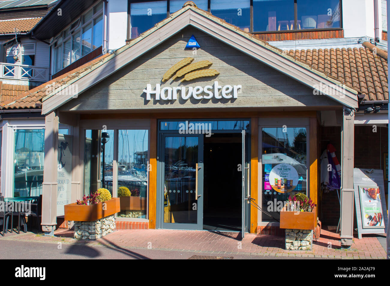 18 September 2019 The Harvester Restaurant in the busy shopping complex surrounding the marina at Port Solent in Hampshire England Stock Photo