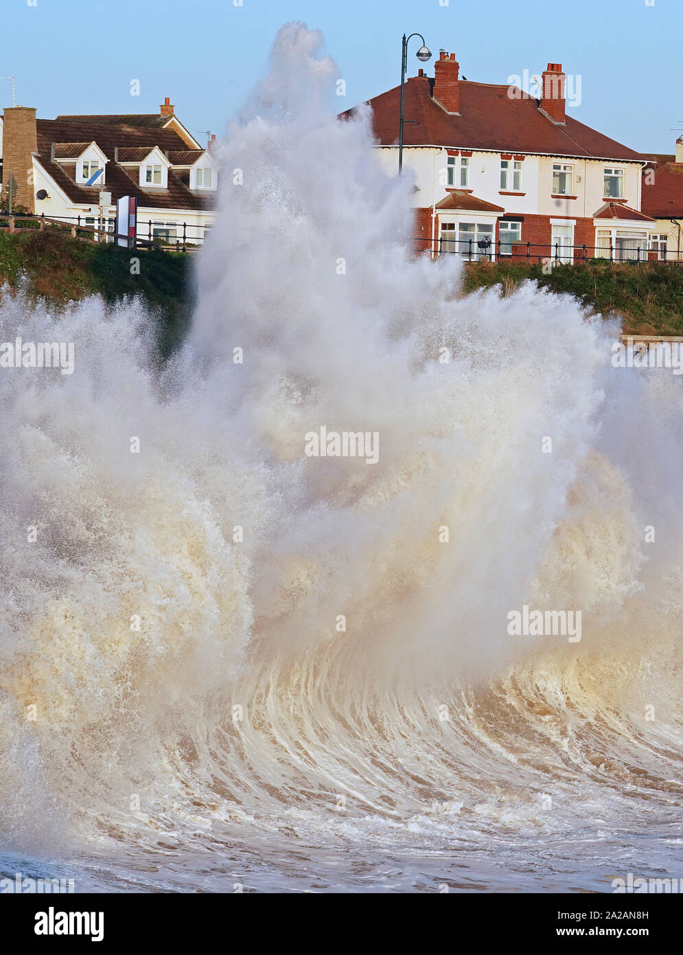 Waves crash against the sea wall at Seaham in County Durham. Elsewhere, a clean-up operation is under way after heavy downpours caused flash flooding across the UK, with some areas hit by a week's rain in just an hour. Stock Photo