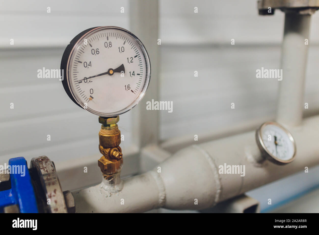 Close up of manometer, pipe, flow meter and faucet valves of heating