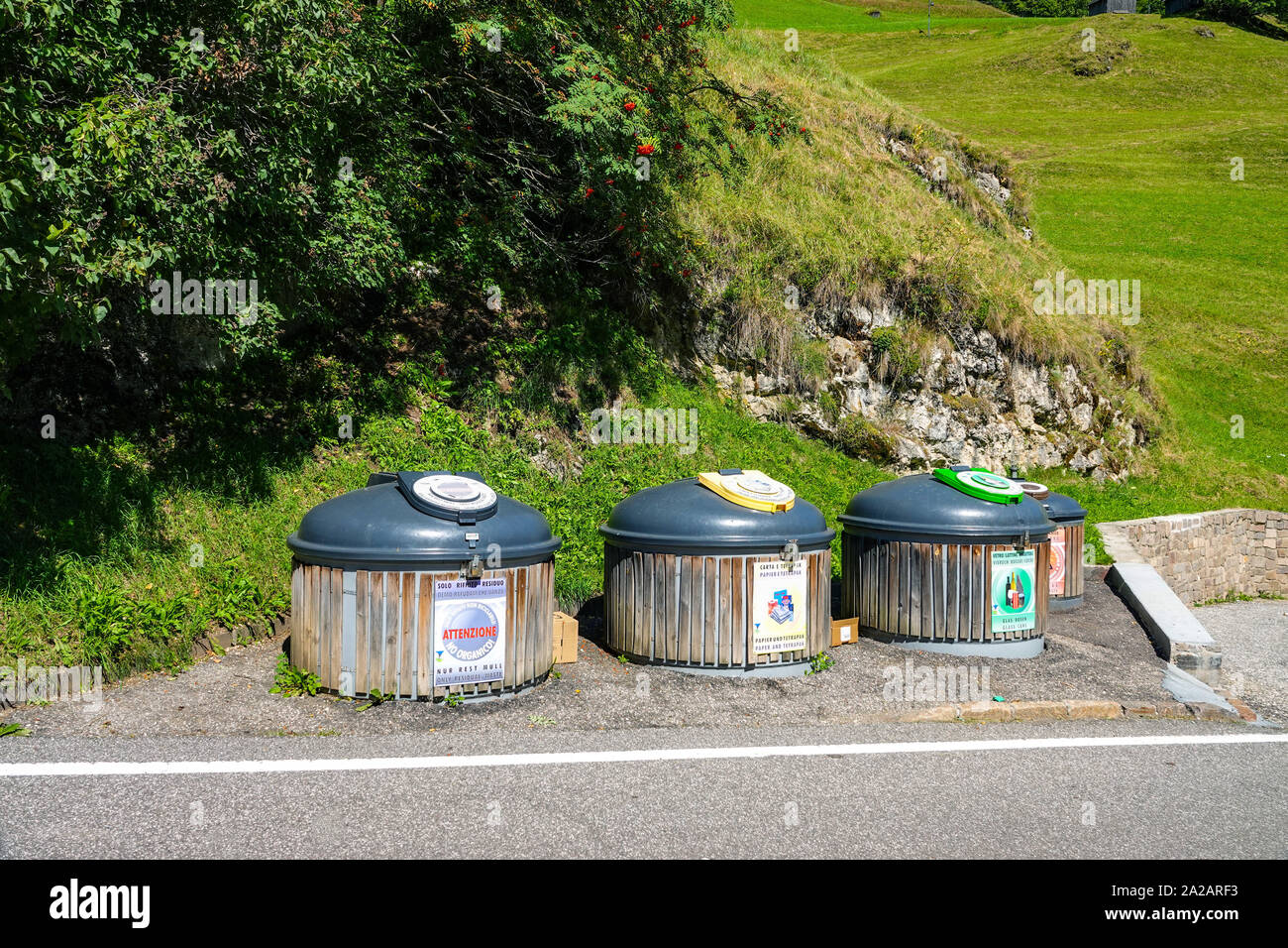 Roadside recycling bins, in the Italian Dolomites, Canazei, Italy Stock