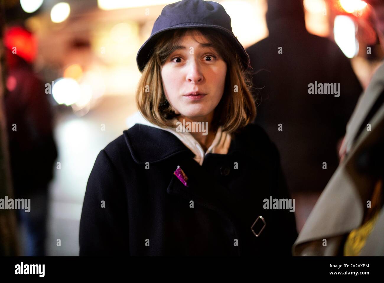 woman making big eyes at night on street Stock Photo