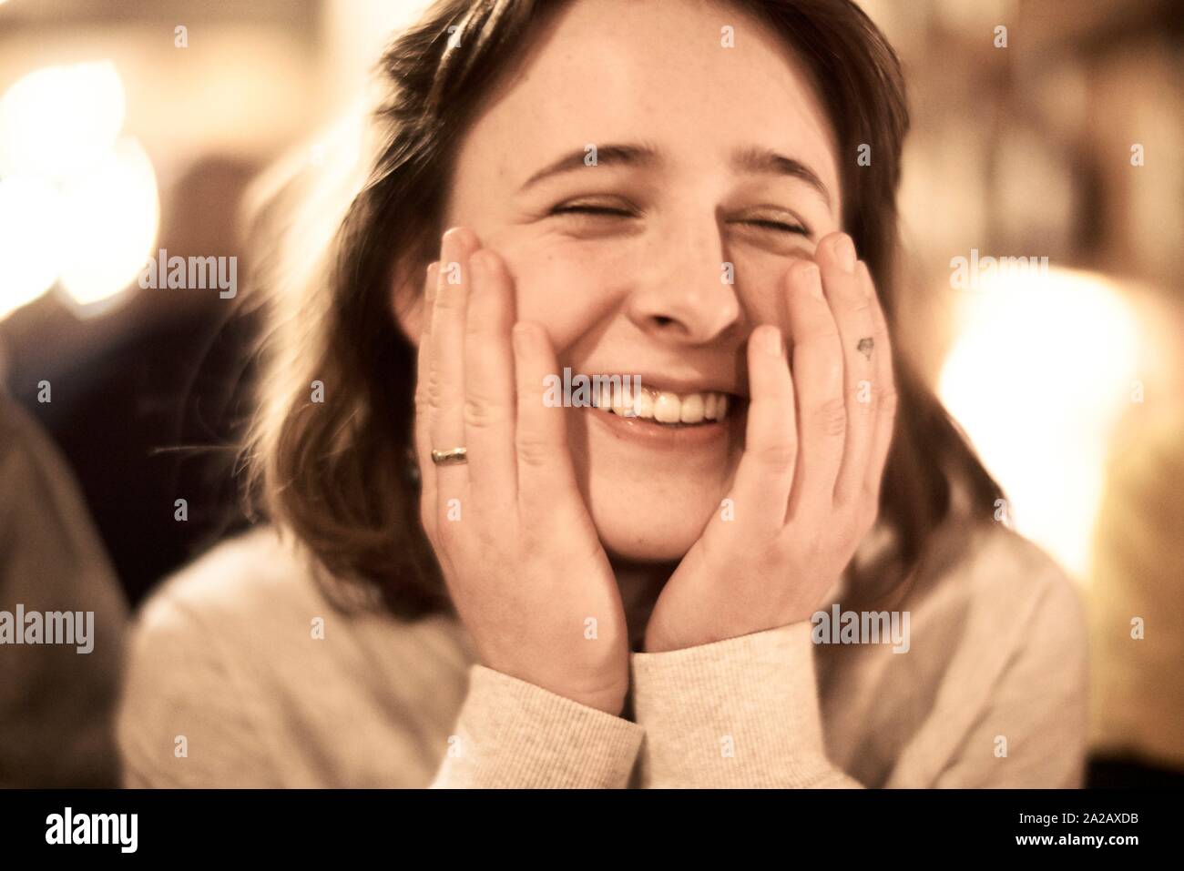 headshot of happy woman indoors in restaurant Stock Photo