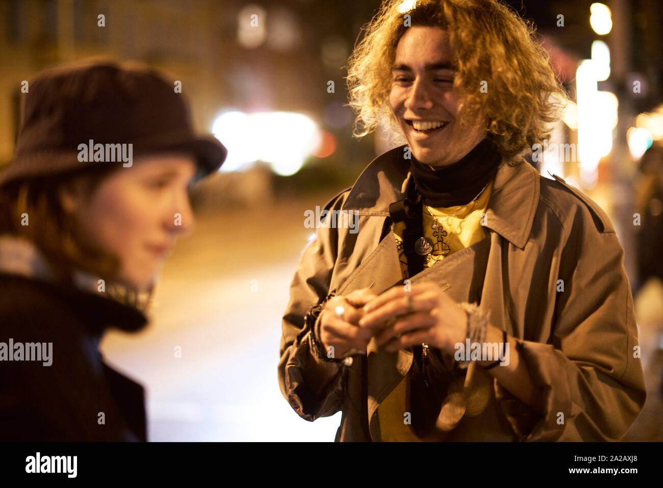 Young couple on the street, nightlife, in Berlin, Germany. Stock Photo