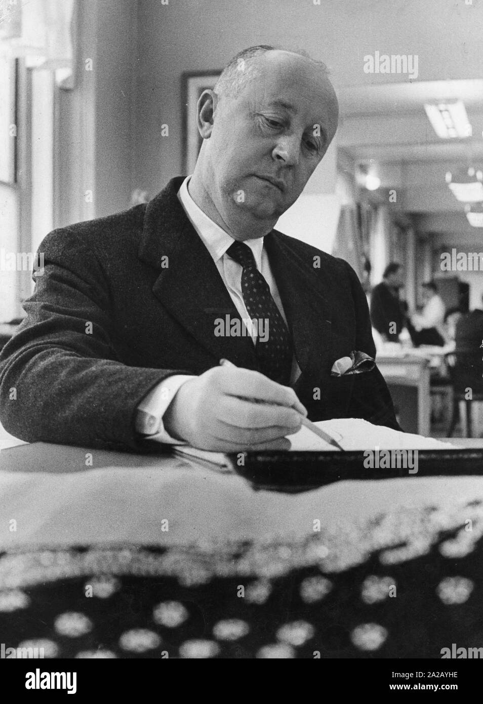 The fashion designer Christian Dior draws sketches Stock Photo Alamy