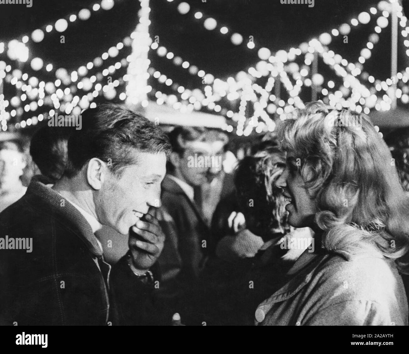 A young couple having fun at a nightly fairground in East Berlin. Stock Photo