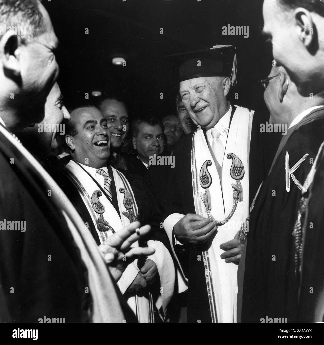 Federal Chancellor Konrad Adenauer is given a graduation cap by the Rector of the University of Tehran. This is the 15th honorary doctor title of Adenauer. Stock Photo