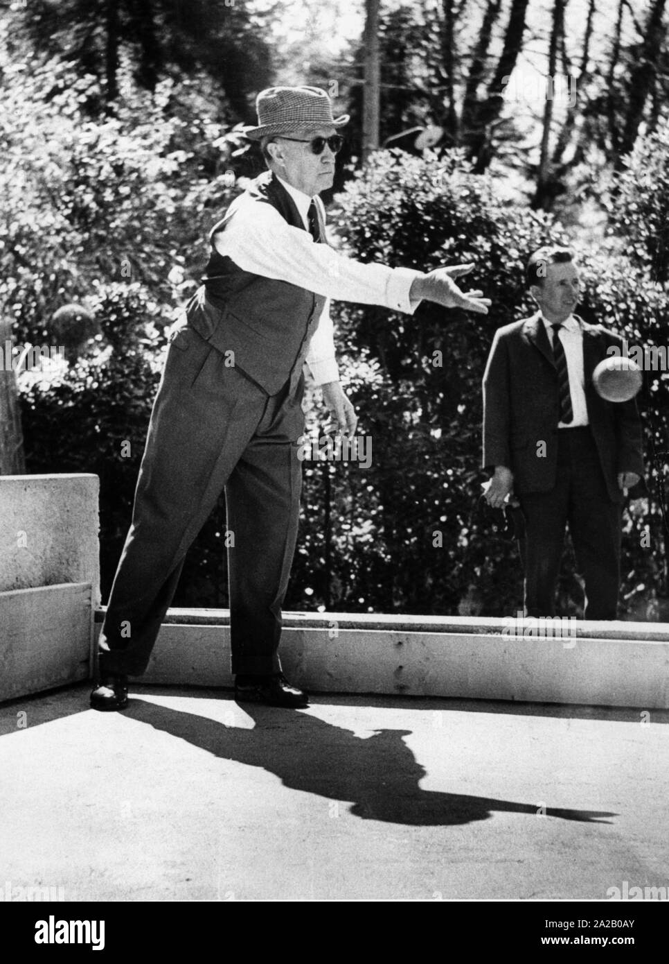 Federal Chancellor Konrad Adenauer plays boccia during his vacation at Villa Arminio in Cadenabbia. He is wearing a pepita hat. Stock Photo