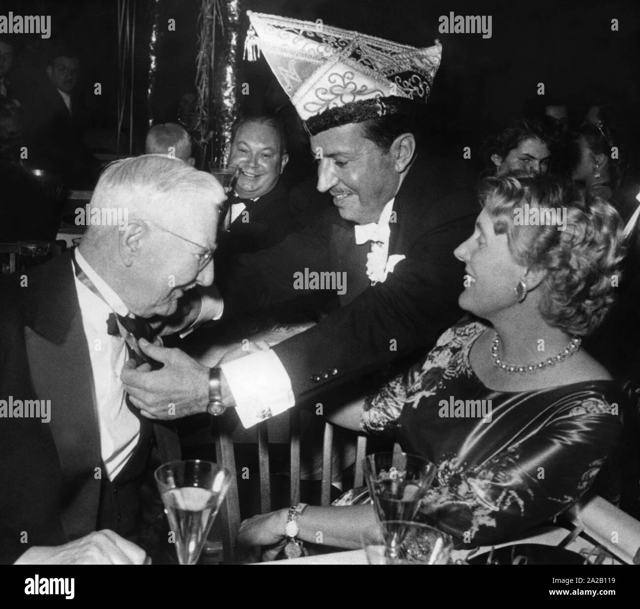 Dr. Hjalmar Schacht receives the Narhalla Carnival Medal at the carnival opening in Munich. At right, wife Manci Vogel. Undated picture, probably 1950s. Stock Photo