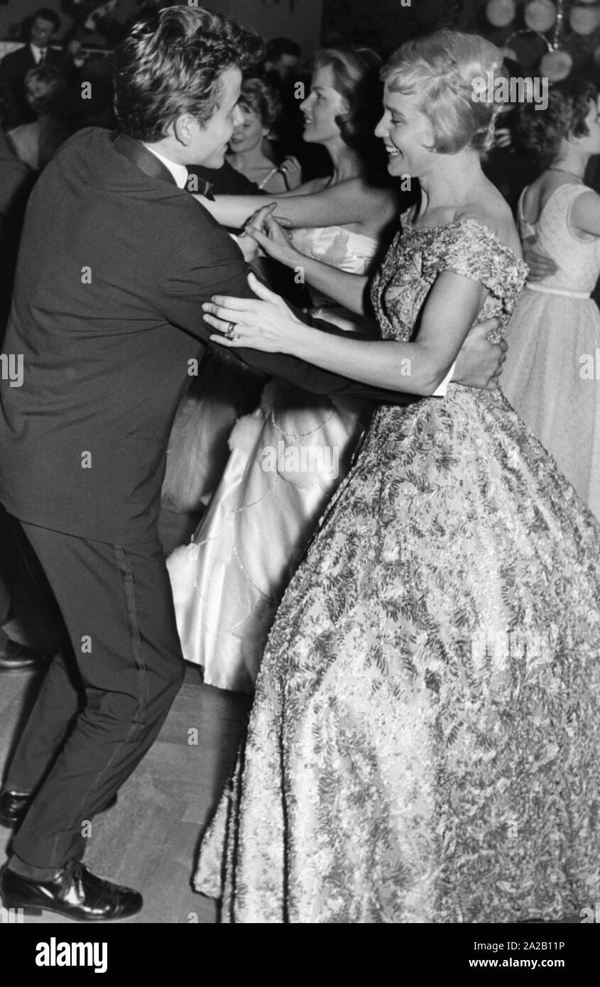 The Austrian-Swiss actress Maria Schell dances with German actor Horst Buchholz, probably on a film or media ball. The picture is probably from the 1950s. Stock Photo