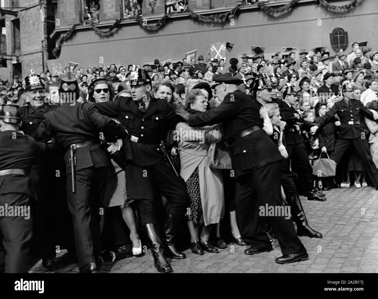Police officers try to push back the enthusiastic crowd at the wedding of Duke Ernst August of Brunswick with Princess Ortrud of Schleswig-Holstein-Gluecksburg in Hanover. Stock Photo